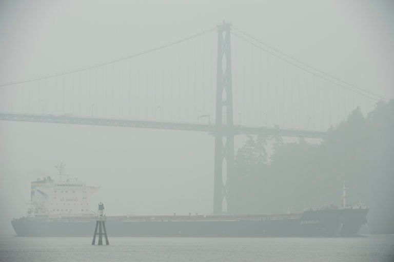 A ship comes through the smoky air under the Lion’s Gate Bridge in Vancouver. (Jonathan Hayward/CP)