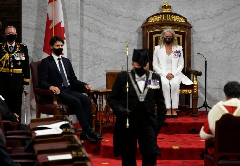 Gov.Gen. Julie Payette, middle, looks on with Chief of Defence Staff Jonathan Vance, left, and Prime Minister Justin Trudeau as the Usher of the Black Rod Greg Peters leaves to summon the House of Commons to come listen to the throne speech in the Senate chamber in Ottawa on Wednesday, Sept. 23, 2020. THE CANADIAN PRESS/Adrian Wyld