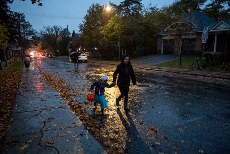 People go trick or treating on Halloween in the rain in Ottawa, on Oct. 31, 2019 (CP/Justin Tang)