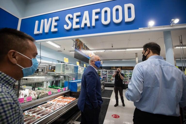 Horgan is given a tour of a supermarket at a campaign stop in Vancouver on Oct. 1, 2020 (CP/Darryl Dyck)