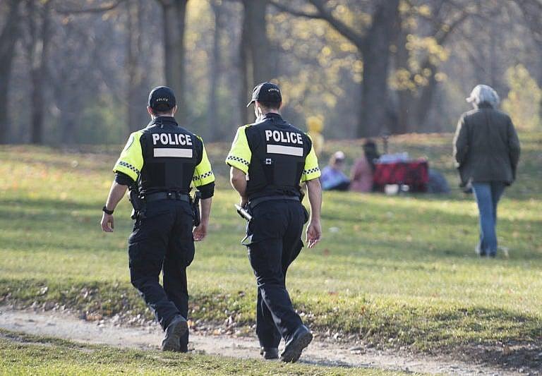 Police patrol Mount Royal Park as people gather on a warm November day in Montreal. (Graham Hughes/CP)