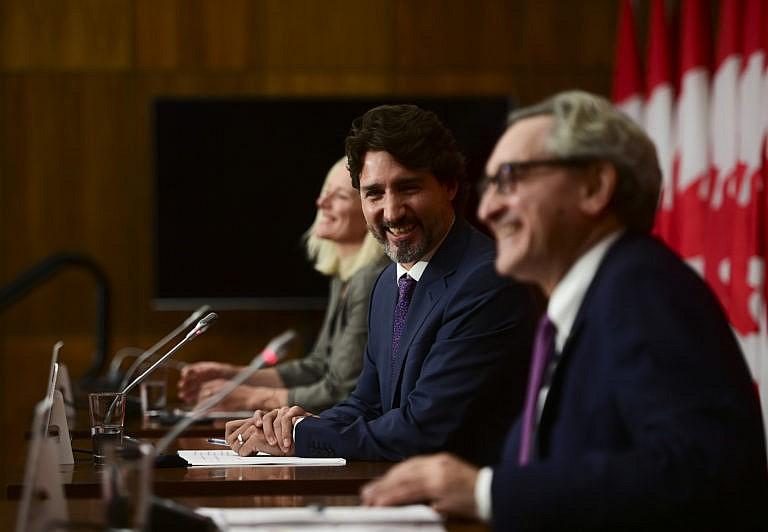 Minister of Infrastructure Catherine McKenna, Trudeau, and Sabia, then chair of the Canada Infrastructure Bank, share a laugh as they hold a press conference in Ottawa on Oct. 1, 2020 (CP/Sean Kilpatrick)
