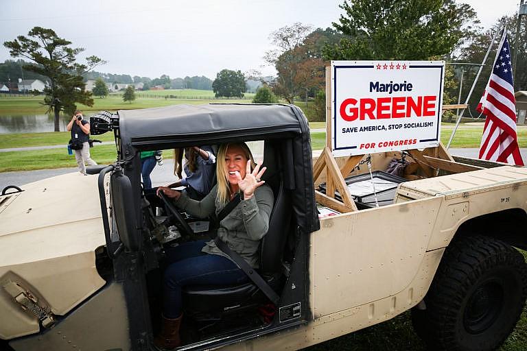 Greene, who has expressed support for the right-wing conspiracy group QAnon, leaves a press conference in a Humvee in Dallas, Ga., this month (Dustin Chambers/Getty Images)
