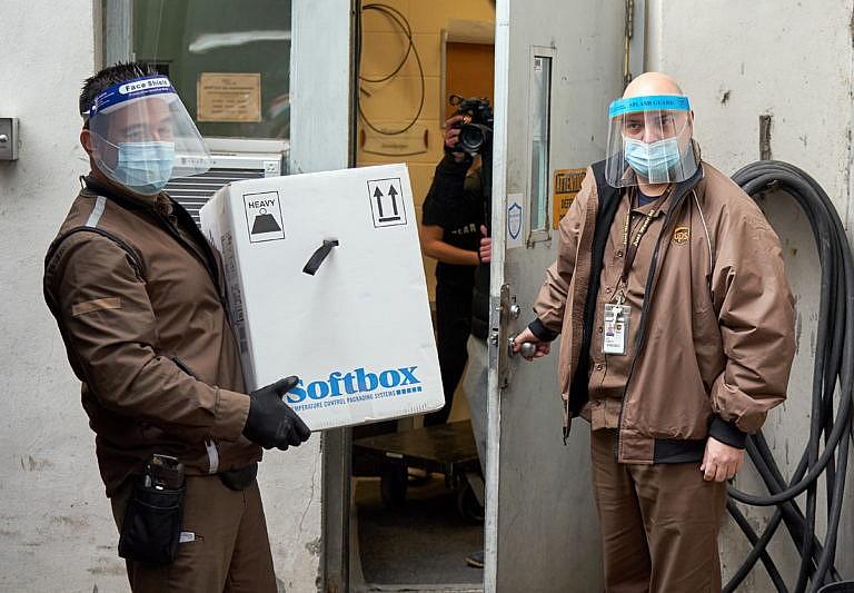 Employees of UPS arrive with the boxes containing the Pfizer/BioNTech COVID-19 vaccines at the CHSLD geriatric care, where the first patients will be vaccinated in Montreal, Canada, 14 December 2020. EPA/ANDRE PICHETTE