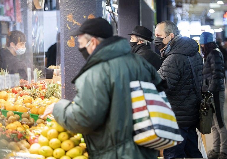 People wear face masks as they shop at a market in Montreal, Sunday, January 17, 2021. THE CANADIAN PRESS/Graham Hughes