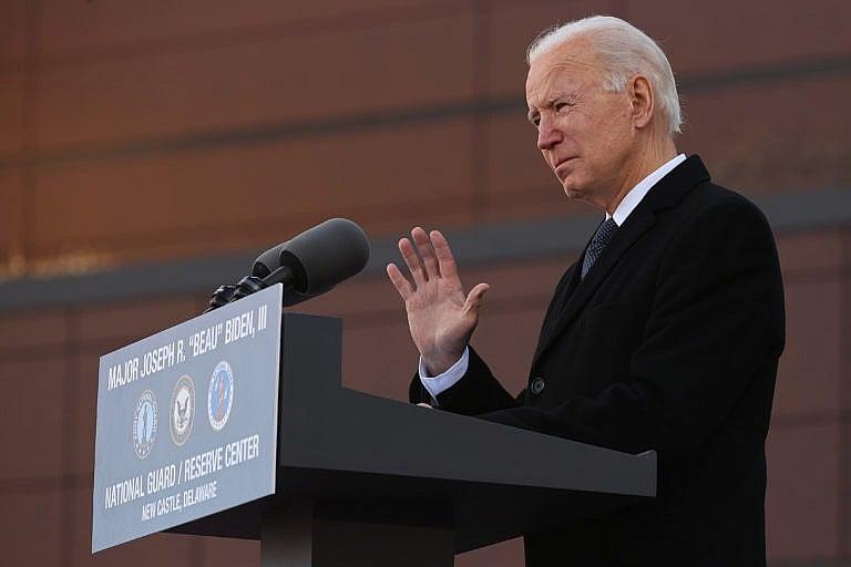 NEW CASTLE, DELAWARE - JANUARY 19: One day before being inaugurated as the 46th president of the United States, President-elect Joe Biden becomes emotional as he delivers remarks at the Major Joseph R. "Beau" Biden III National Guard/Reserve Center. (Photo by Chip Somodevilla/Getty Images)