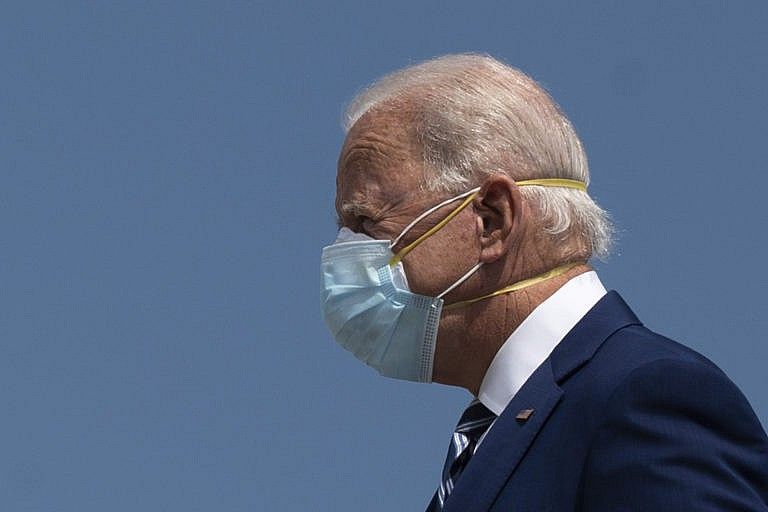 Democratic Presidential Candidate Joe Biden wears two masks as he arrives in Fort Lauderdale, Florida on October 13, 2020. - Joe Biden headed for Florida on Tuesday to court elderly Americans who helped elect Donald Trump four years ago but appear to be swinging to the Democratic candidate for the White House this time around amid the coronavirus pandemic. Biden, at 77 the oldest Democratic nominee ever, is to "deliver his vision for older Americans" at an event in the city of Pembroke Pines, north of Miami, his campaign said. (Photo by JIM WATSON / AFP) (Photo by JIM WATSON/AFP via Getty Images)