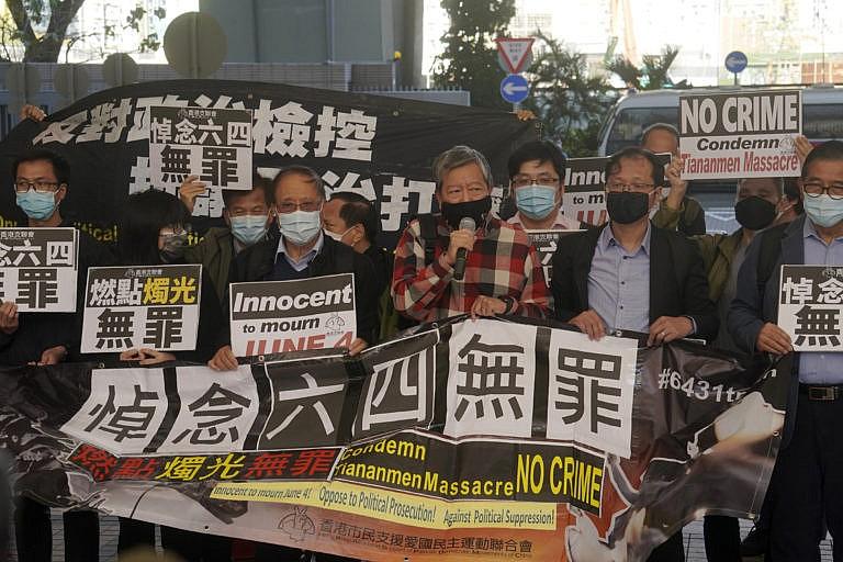 Pro-democracy protestors gather Friday during the court appearance in Hong Kong of two dozen activists charged with unauthorized assembly; the accused had attended a vigil commemorating the 1989 Tiananmen crackdown.(Kin Cheung/AP)