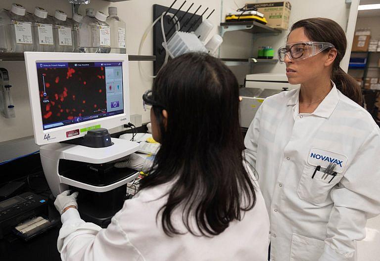 Dr. Sonia Macieiewski (R) and Dr. Nita Patel, Director of Antibody discovery and Vaccine development, look at a sample of a respiratory virus at Novavax labs in Gaithersburg, Maryland on March 20, 2020, for the coronavirus, COVID-19. (Photo by ANDREW CABALLERO-REYNOLDS/AFP via Getty Images)