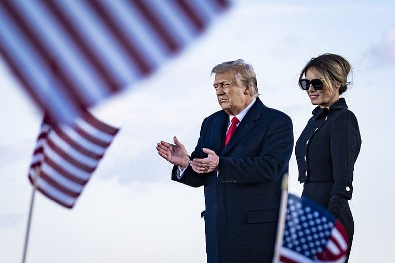 JOINT BASE ANDREWS, MARYLAND - JANUARY 20: President Donald Trump and First Lady Melania Trump on stage after speaking to supporters at Joint Base Andrews before boarding Air Force One for his last time as President on January 20, 2021 in Joint Base Andrews, Maryland. Trump, the first president in more than 150 years to refuse to attend his successor's inauguration, is expected to spend the final minutes of his presidency at his Mar-a-Lago estate in Florida. (Photo by Pete Marovich - Pool/Getty Images)