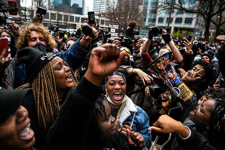 People celebrate as the verdict is announced in the trial of former police officer Derek Chauvin outside the Hennepin County Government Center in Minneapolis, Minnesota on April 20, 2021. - Sacked police officer Derek Chauvin was convicted of murder and manslaughter on april 20 in the death of African-American George Floyd in a case that roiled the United States for almost a year, laying bare deep racial divisions. (Chandan Khanna/AFP/Getty Images)