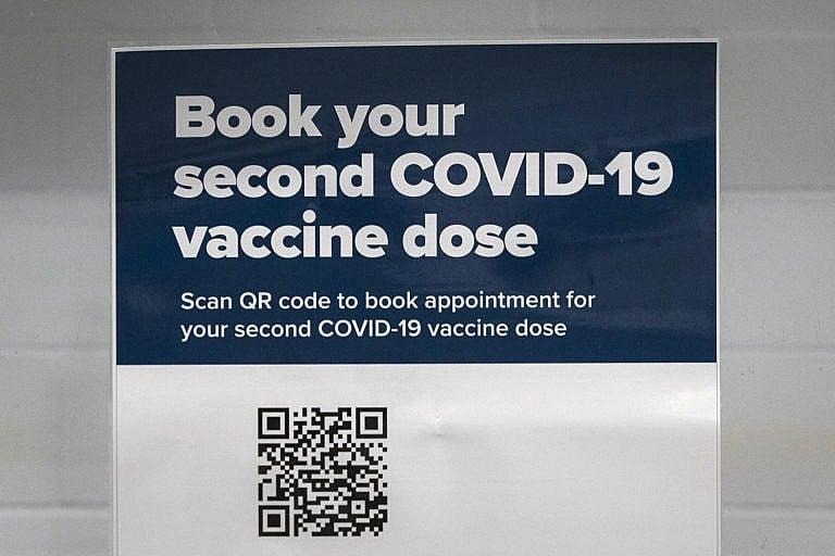 Sign that says "Book your second COVID-19 vaccine dose" at the Invista Centre in Kingston, Ontario on Monday, March 1, 2021, as the COVID-19 pandemic continues across Canada and around the world. THE CANADIAN PRESS IMAGES/Lars Hagberg