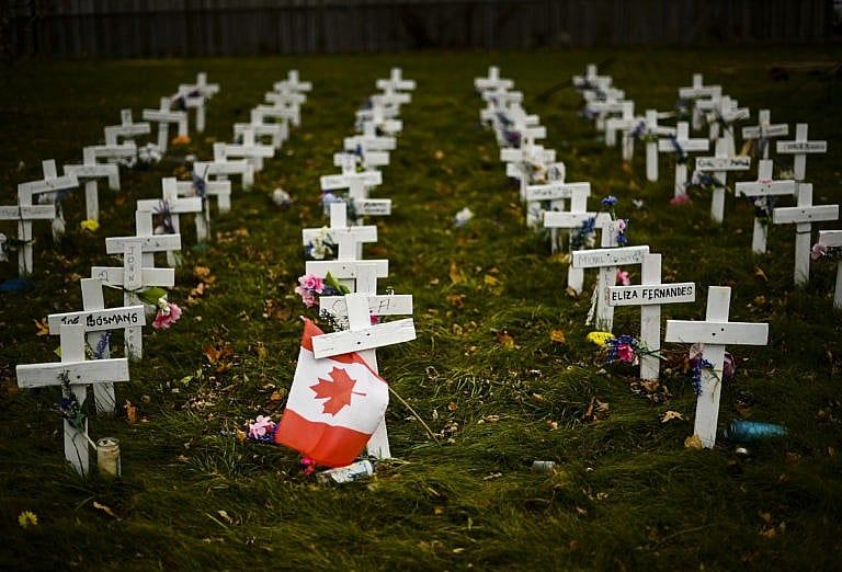 Miniature crosses planted last year in memory of the elderly who died from COVID-19 at a long-term facility in Mississauga, Ont., summoned the image of war cemeteries in Europe. (Nathan Denette/CP)