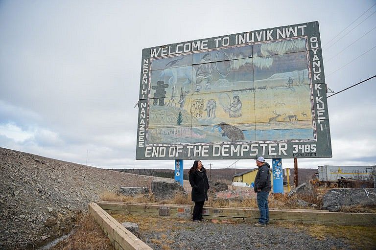 Kristine McLeod, deputy grand chief of Gwich’in Tribal Council, and Kelly McLeod, President of the Nihtat Gwich'in at the Inuvik sign they plan to restore (Photograph by Tony Devlin)