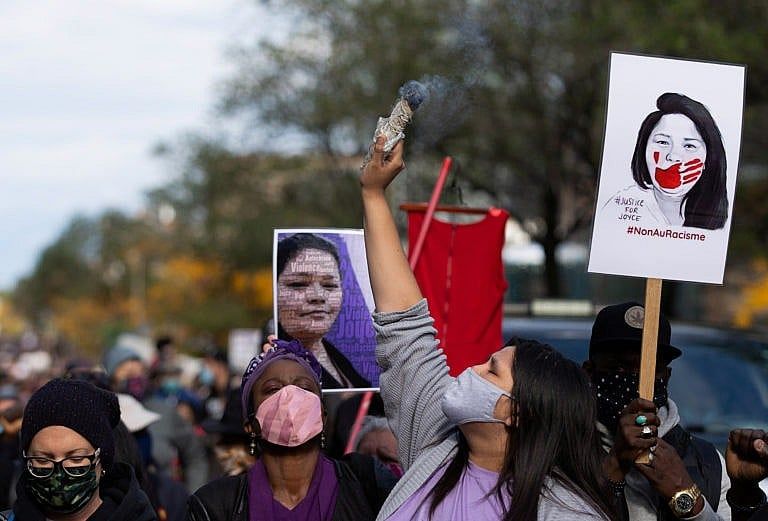 A woman smudges during a march to demand justice and raise awareness for Echaquan (Christinne Muschi/Reuters)