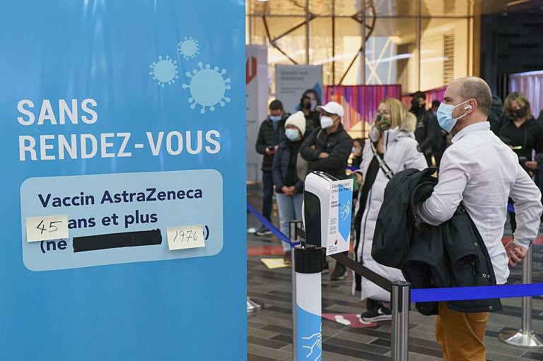 People lining up at walk-in COVID-19 vaccination clinic to receive the AstraZeneca vaccine in Montreal, on Wednesday, April 21, 2021. THE CANADIAN PRESS/Paul Chiasson