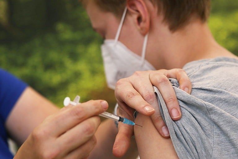 June 9, 2021, North Rhine-Westphalia, Viersen: A pediatrician vaccinates a boy with Biontech-Pfizer's Comirnaty corona vaccine. Photo: David Young/dpa (Photo by David Young/picture alliance via Getty Images)