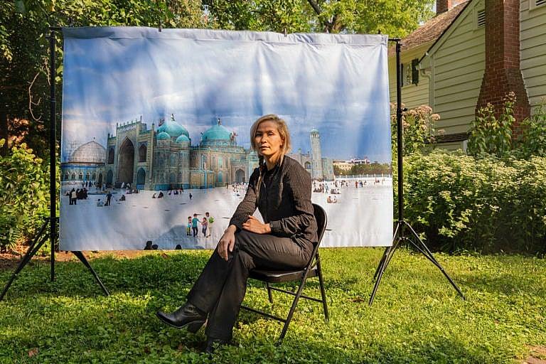 Hadia Essazada (Photograph by Farrah Skeiky; mural photograph: Wasim Mirzaie)