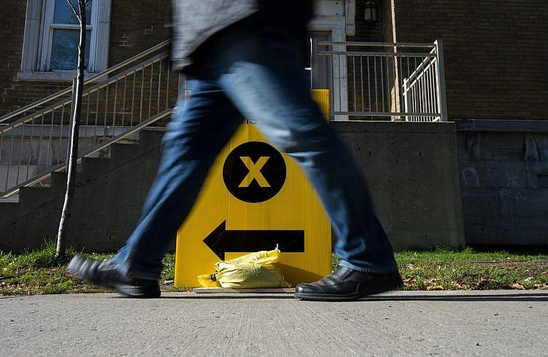 A person walks towards a polling station on election day in Ottawa on Oct. 21, 2019 (Justin Tang/CP)
