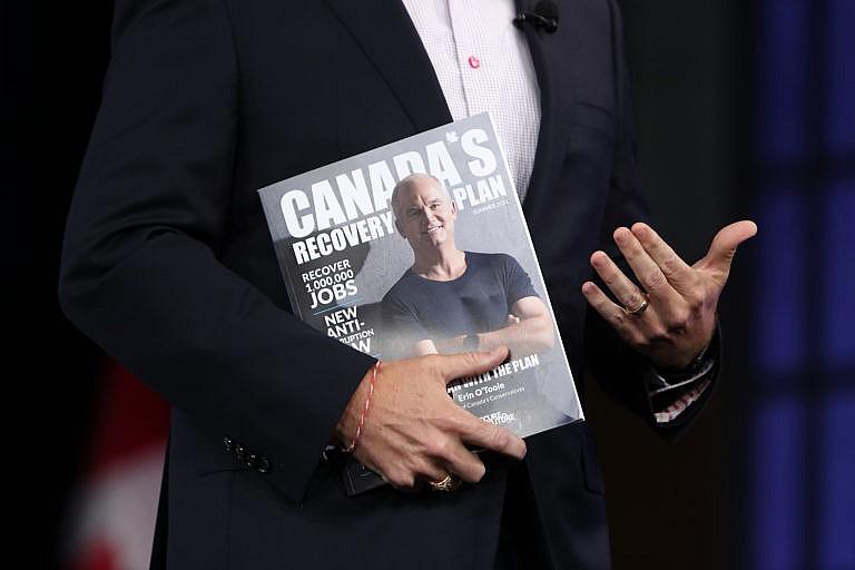 Erin O'Toole, leader of Canada's Conservative Party, holds a magazine featuring his recovery plan during a campaign event in Ottawa, Ontario, Canada, on Monday, Aug. 16, 2021. Prime Minister Justin Trudeau called an election for Sept. 20, seeking to retake a majority in Canadas parliament on the back of polls showing many voters approve of his governments handling of the coronavirus pandemic. Photographer: David Kawai/Bloomberg via Getty Images