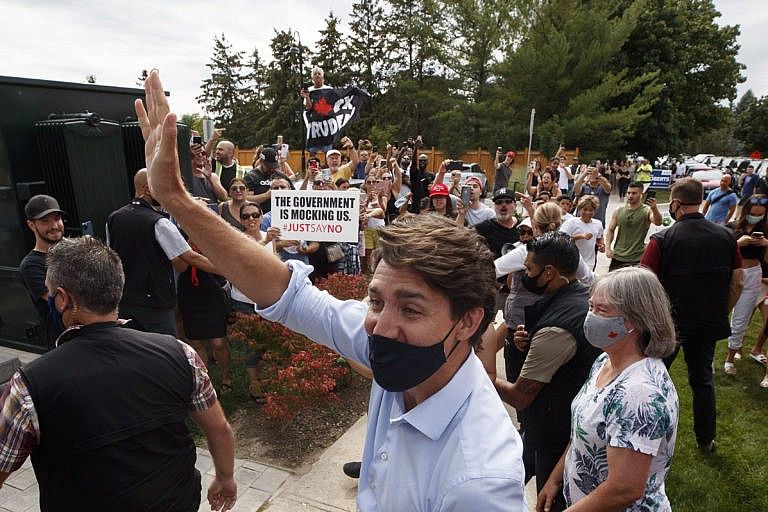 Demonstrators shout as Justin Trudeau, Canada's prime minister, arrives to campaign stop in Nobleton, Ontario, Canada, on Friday, Aug. 27, 2021. Trudeaus campaign rally in Bolton, Ontario, was canceled over security concerns amid protests. (Cole Burston/Bloomberg/Getty Images)