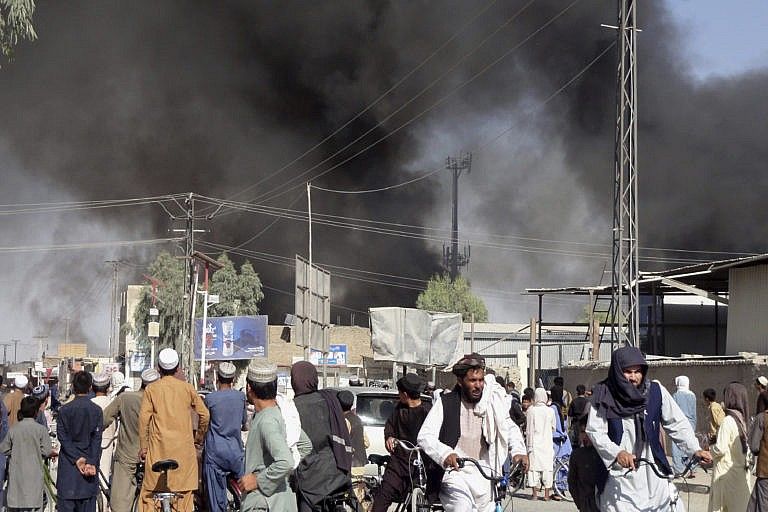 Smoke rises in Kandahar after fighting on Thursday between the Taliban and Afghan security personnel. The Taliban say they've taken control of the city. (Sidiqullah Khan/AP)