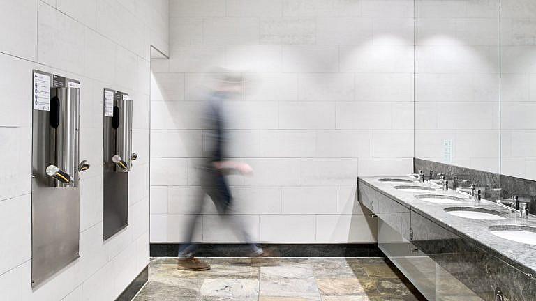 Person (blurry) entering a washroom