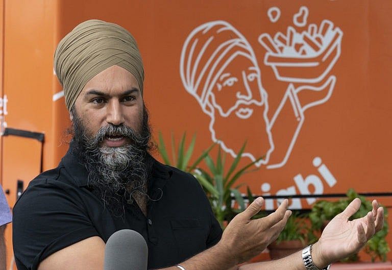 Singh addresses reporters in front of the Poutine Punjabi food truck in Montreal. (Adrian Wyld/CP)