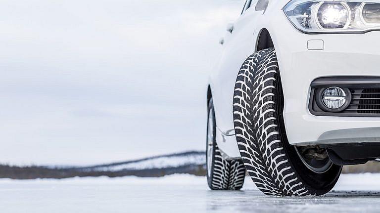 Car with winter tires on icy surface