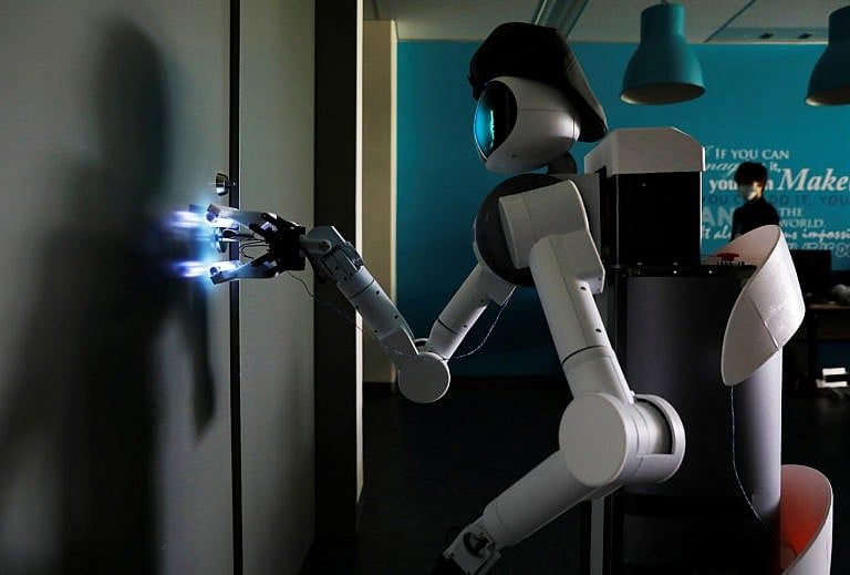 Mira Robotics' Ugo avatar robot sterilizes a door handle with ultraviolet light during a demonstration at the company's laboratory in Kawasaki, Japan, June 8, 2020 (Kim Kyung-Hoon/Reuters)