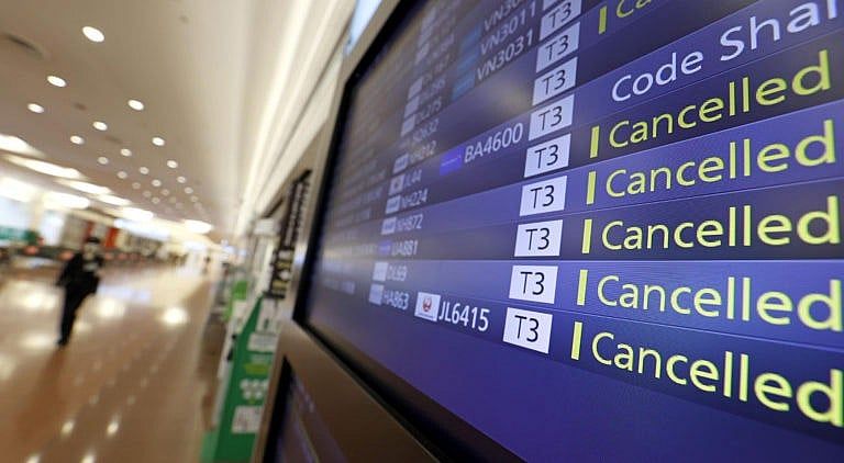 Flight cancelations are seen on the information board at Haneda Airport in Tokyo, Japan, Nov. 30, 2021. Japan confirmed on Tuesday its first case of the new Omicron coronavirus variant. (Shinji Kita/Kyodo News via AP)