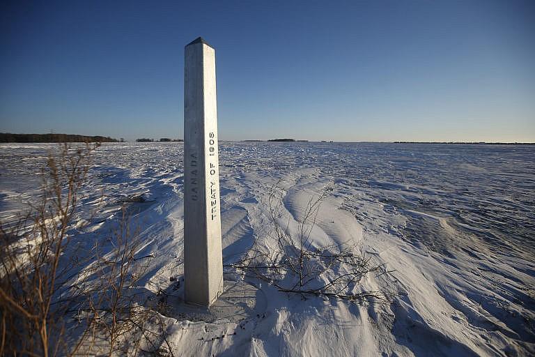 A border marker is shown just outside of Emerson, Man. on Jan. 20, 2022. American investigators believe the deaths of four people, including a baby and a teen, whose bodies were found in Manitoba near the United States border are linked to a larger human smuggling operation. (John Woods/The Canadian Press)
