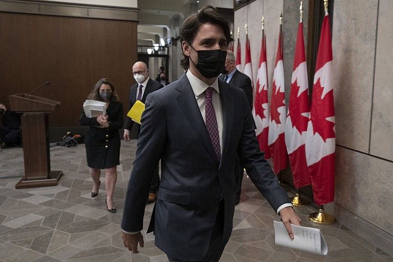 Trudeau leaves a news conference after announcing the Emergencies Act will be invoked, on Feb. 14, 2022 (Adrian Wyld/CP)