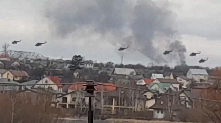 Military helicopters, apparently Russian, fly over the outskirts of Kyiv, Ukraine, Feb. 24, 2022. (Ukrainian Police Department Press Service via AP)