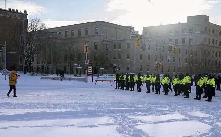 Police face off with a protester against COVID-19 mandates, Feb. 18, 2022 in Ottawa. (Robert Bumsted/Associated Press)