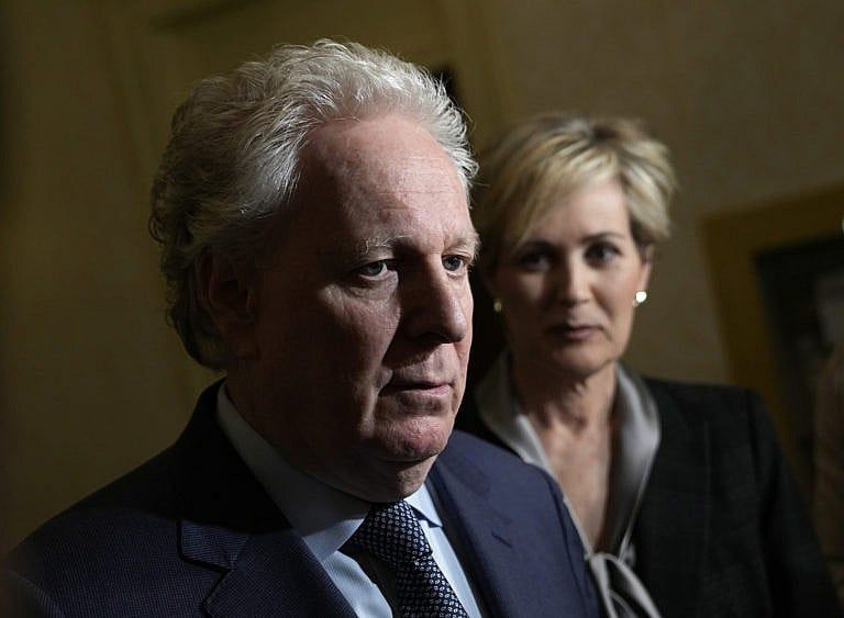 Former Quebec premier Jean Charest speaks to reporters as he arrives with his wife Michele Dionne for an event with potential caucus supporters as he considers a run for the leadership of the Conservative Party of Canada, in Ottawa, March 2, 2022. (Justin Tang/The Canadian Press)
