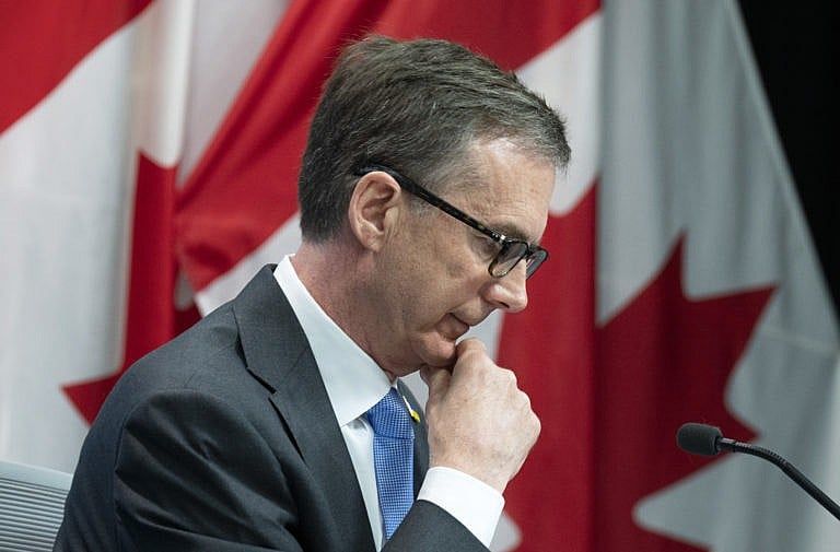 Bank of Canada Governor Tiff Macklem listens to a question from a reporter during a news conference following a rate announcement, April 13, 2022 in Ottawa. (Adrian Wyld/The Canadian Press)