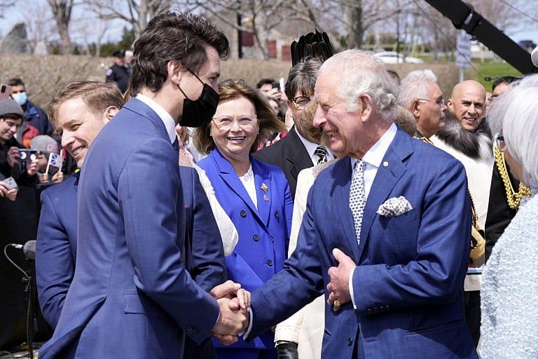 Prime Minister Justin Trudeau greets Prince Charles and Camilla, Duchess of Cornwall as they arrive in St. John's to begin a three-day Canadian tour, May 17, 2022. (Paul Chiasson/The Canadian Press)
