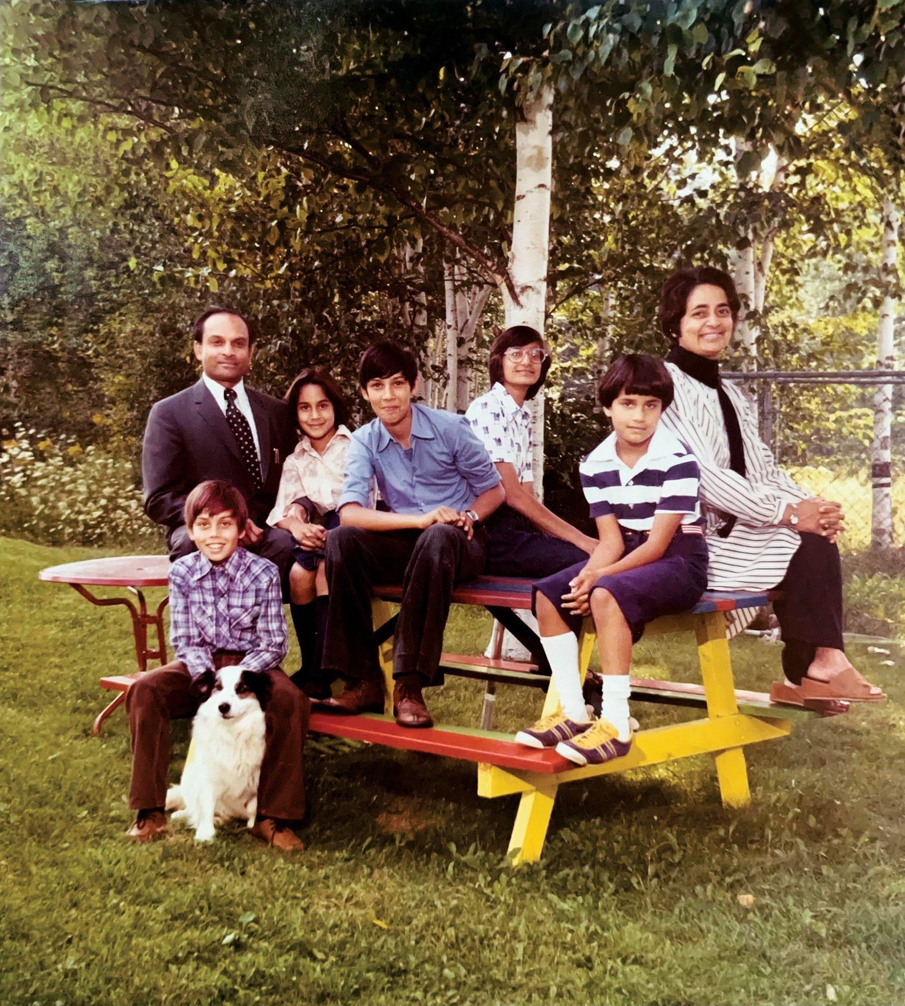 Anand, shown here with her parents and cousins in the backyard of her childhood home, grew up in Kentville, Nova Scotia. She appears third from left, seated next to her father.Â 