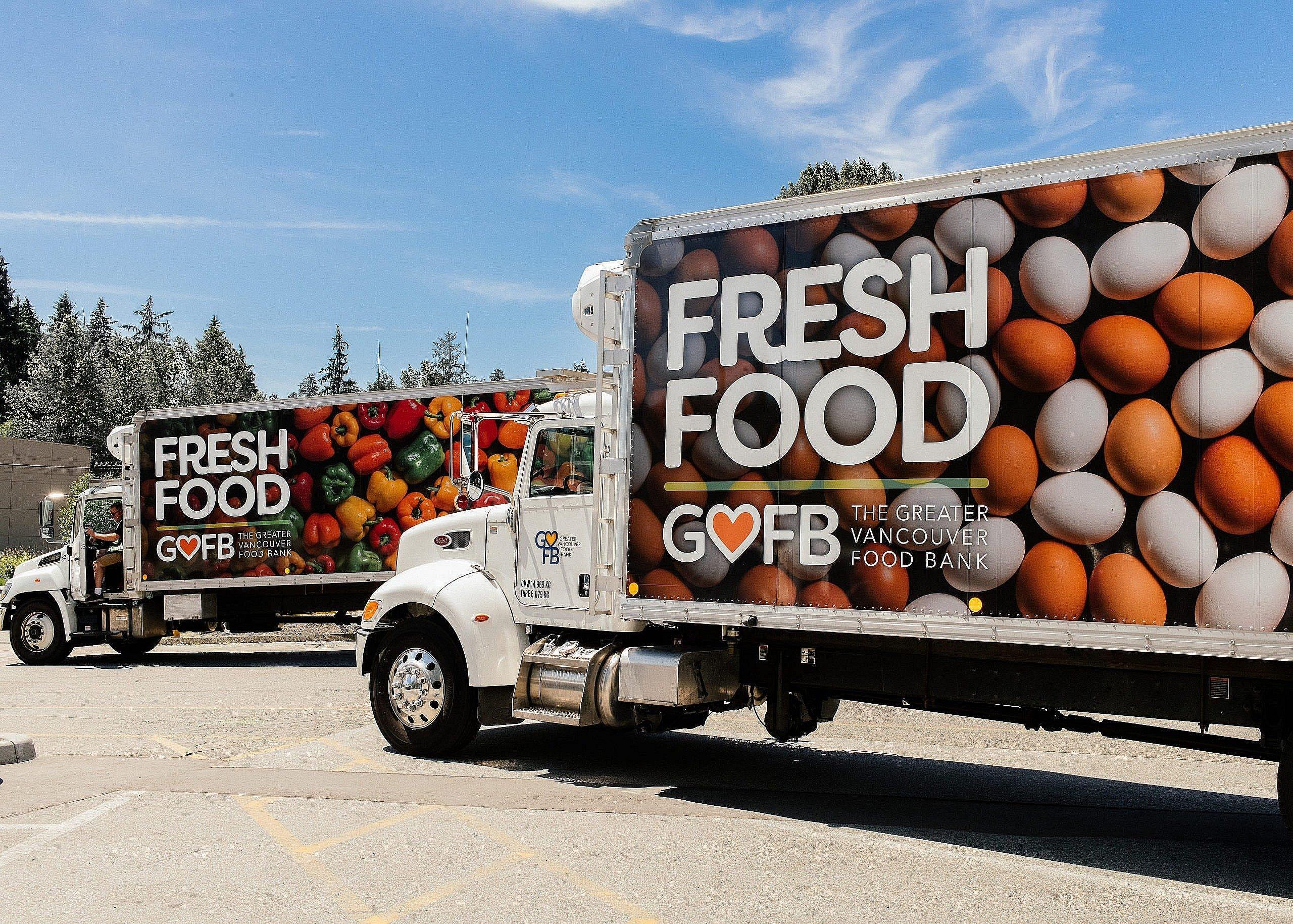 Two trucks with the words "Fresh Food" on them, with various coloured eggs on the side of the truck