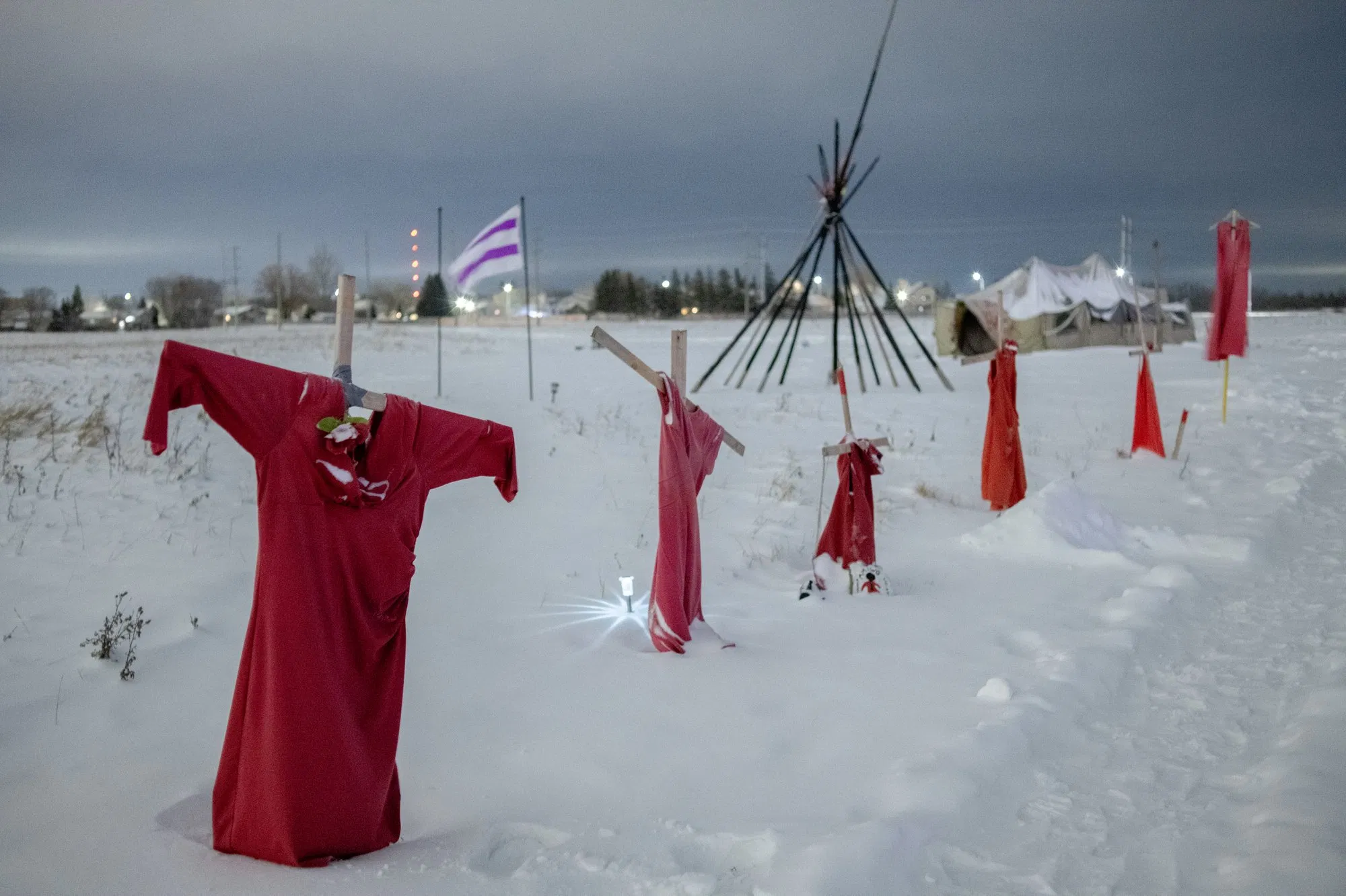A picture of red dresses hanging in the snow